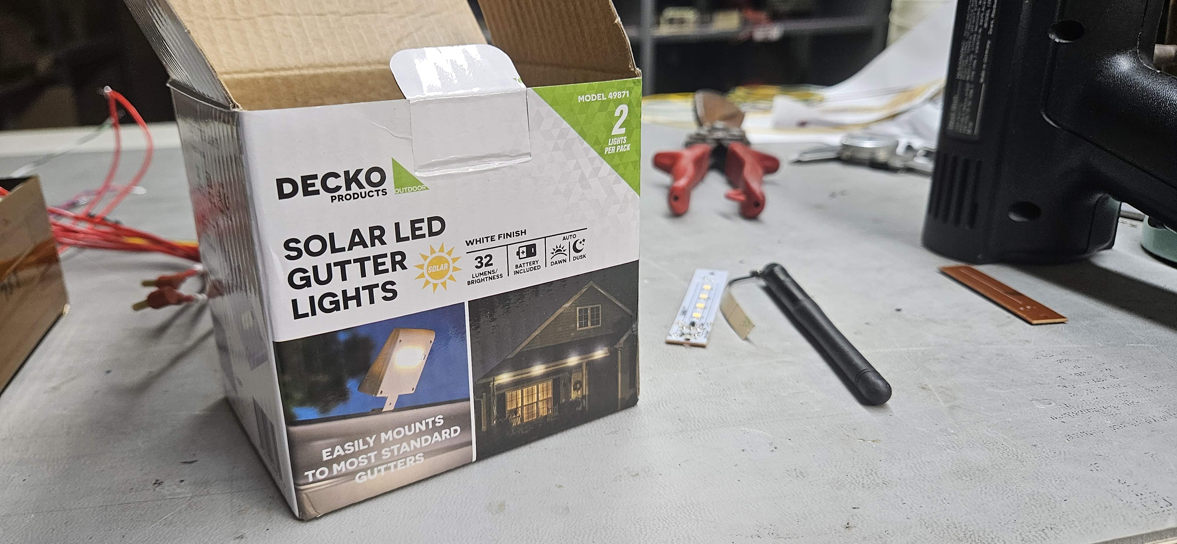 Decko Solar Gutter Light packaging next to original LED board strip